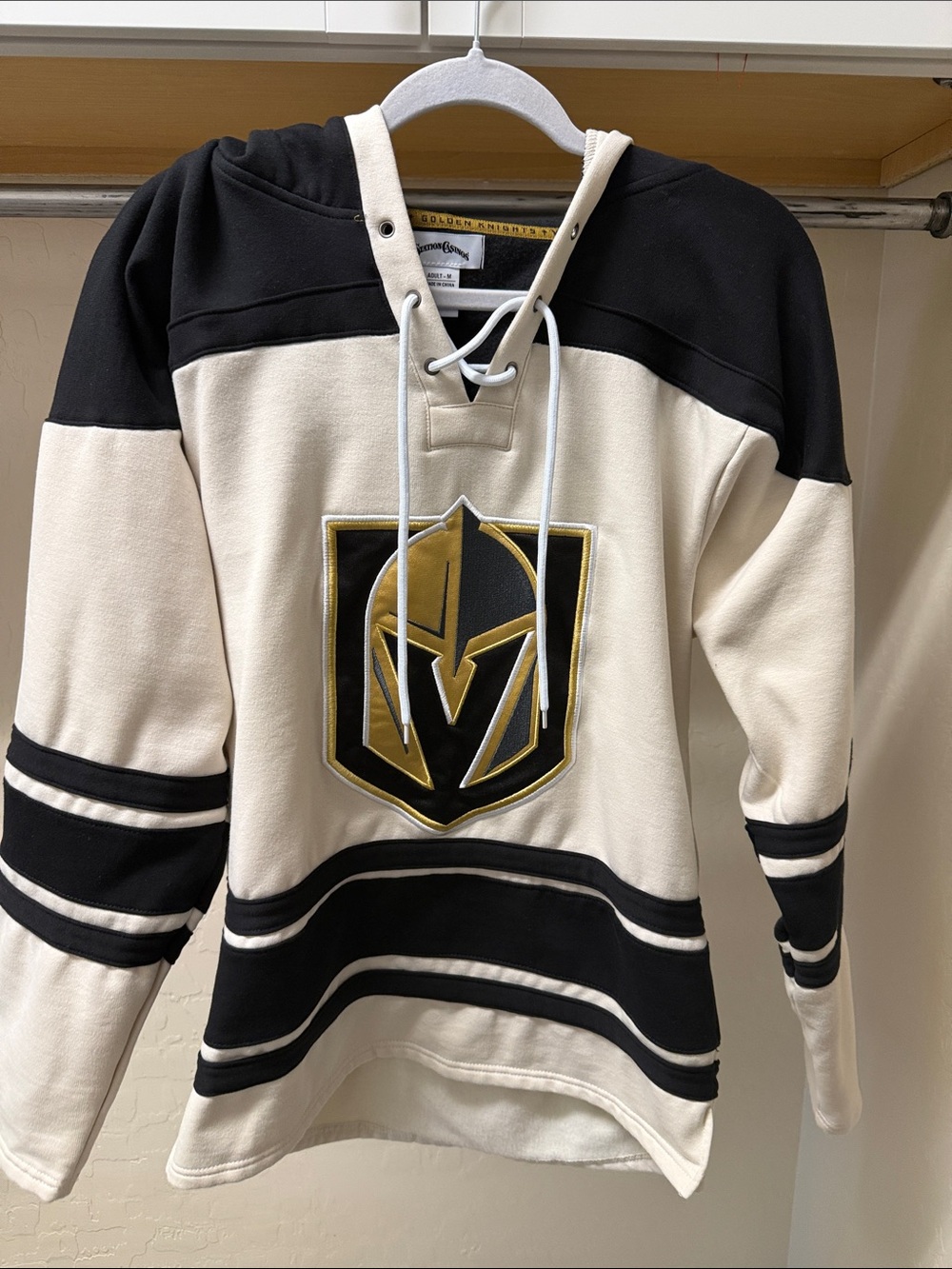 Men's Cream and Black Hockey Pullover Hoodie with Golden Knight logo